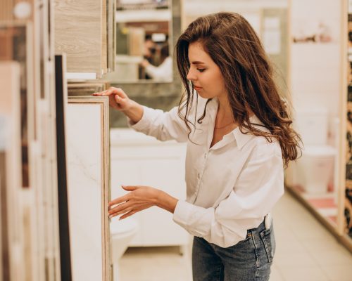 Young sales woman working at building market